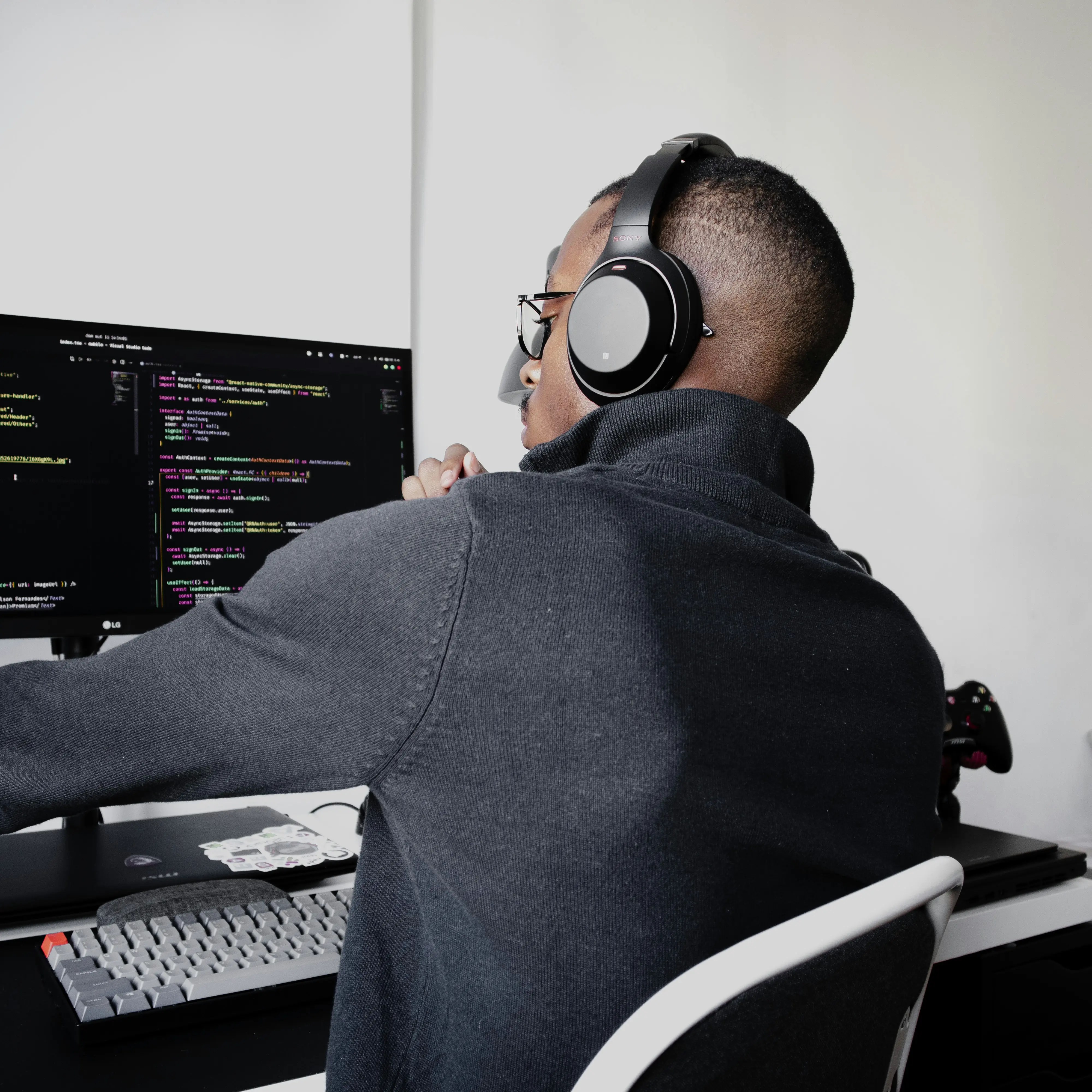 Developer at a desk writing backend authentication code